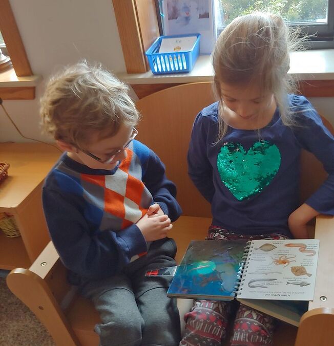 Boy and Girl reading at Leelanau Montessori