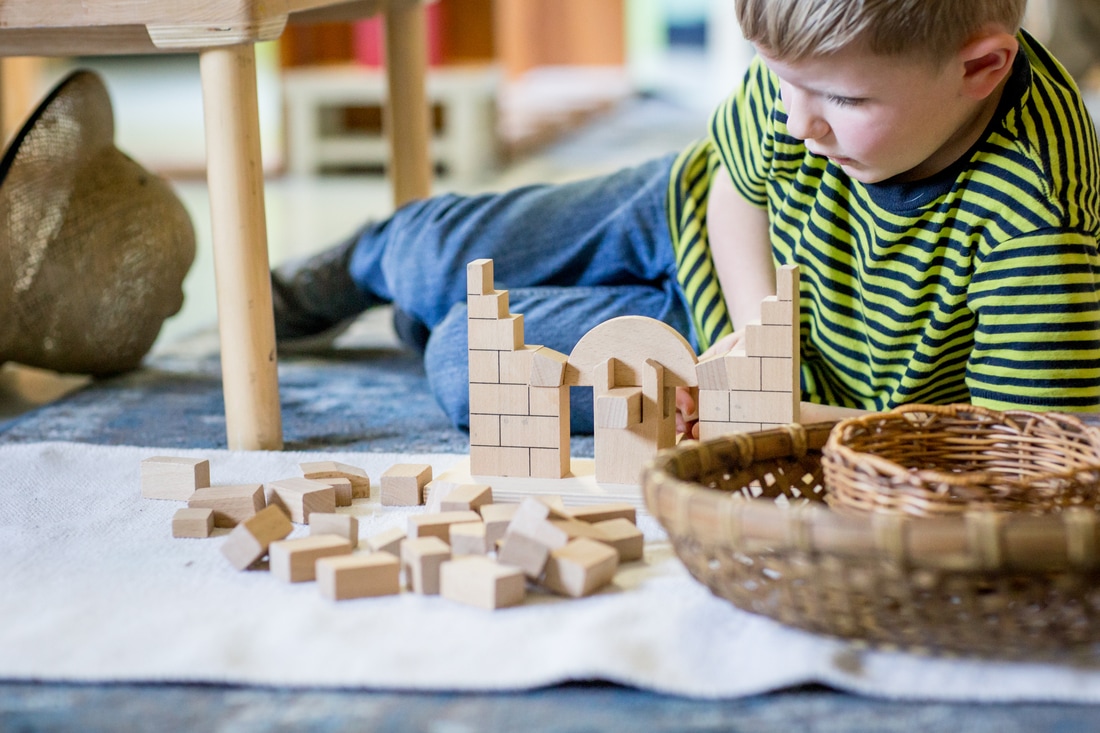 boy builds with blocks